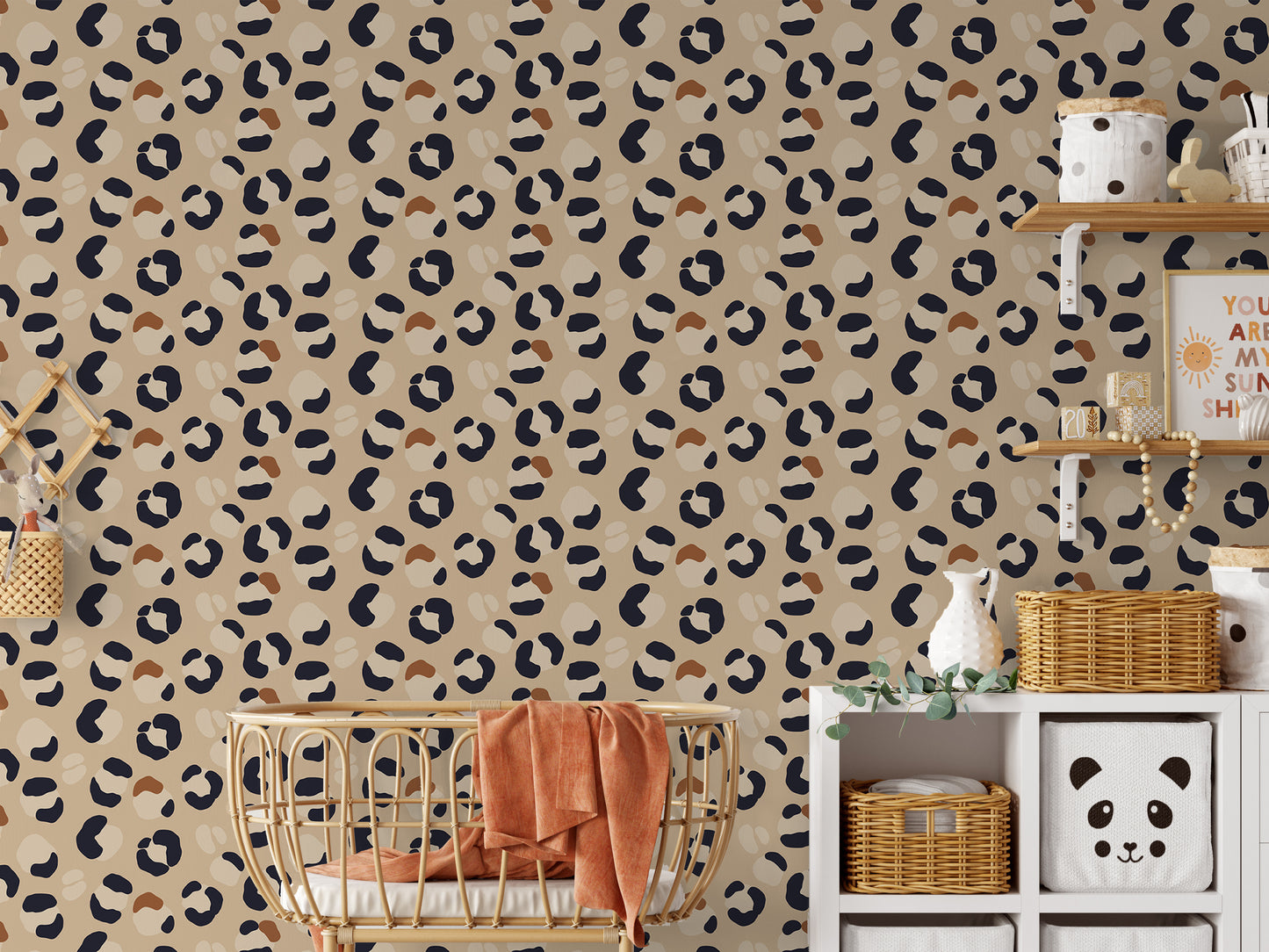 Leopard print wallpaper in a babies bedroom