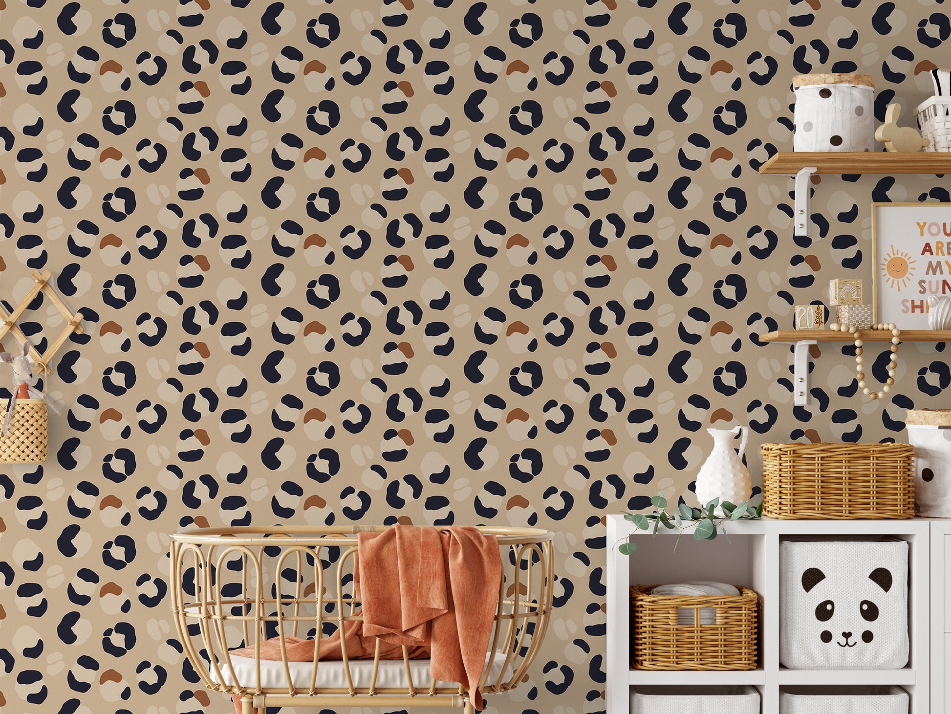 Leopard print wallpaper in a babies bedroom