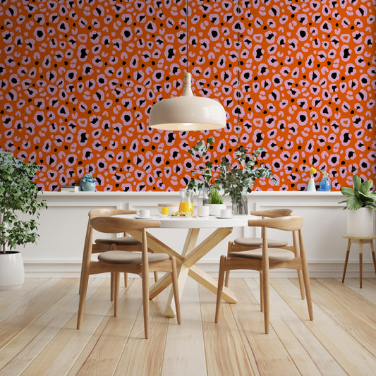 Orange , pink and black cheetah print wallpaper in a dining room
